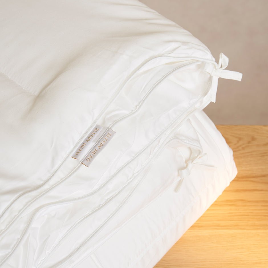 Warm duvet and pillow in a bedroom set to the ideal winter sleep temperature