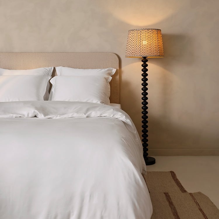 White percale hotel bedding with visible weave structure in morning light