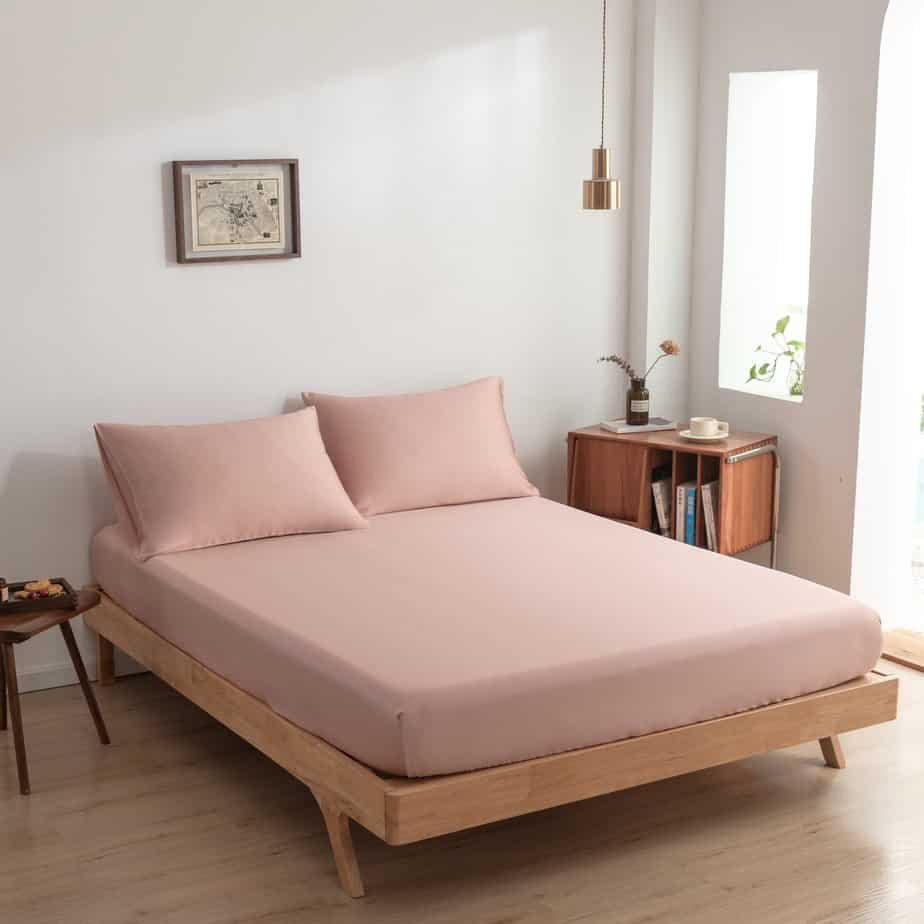 Cuddle Pink bamboo bedding set on a bed, wide bedroom view