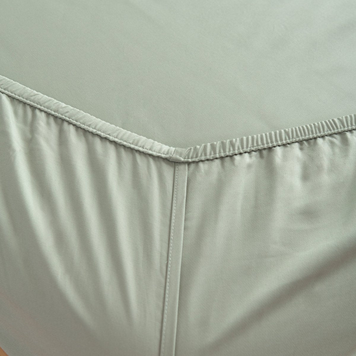 Sage Green bamboo bedding set on a bed, corner view