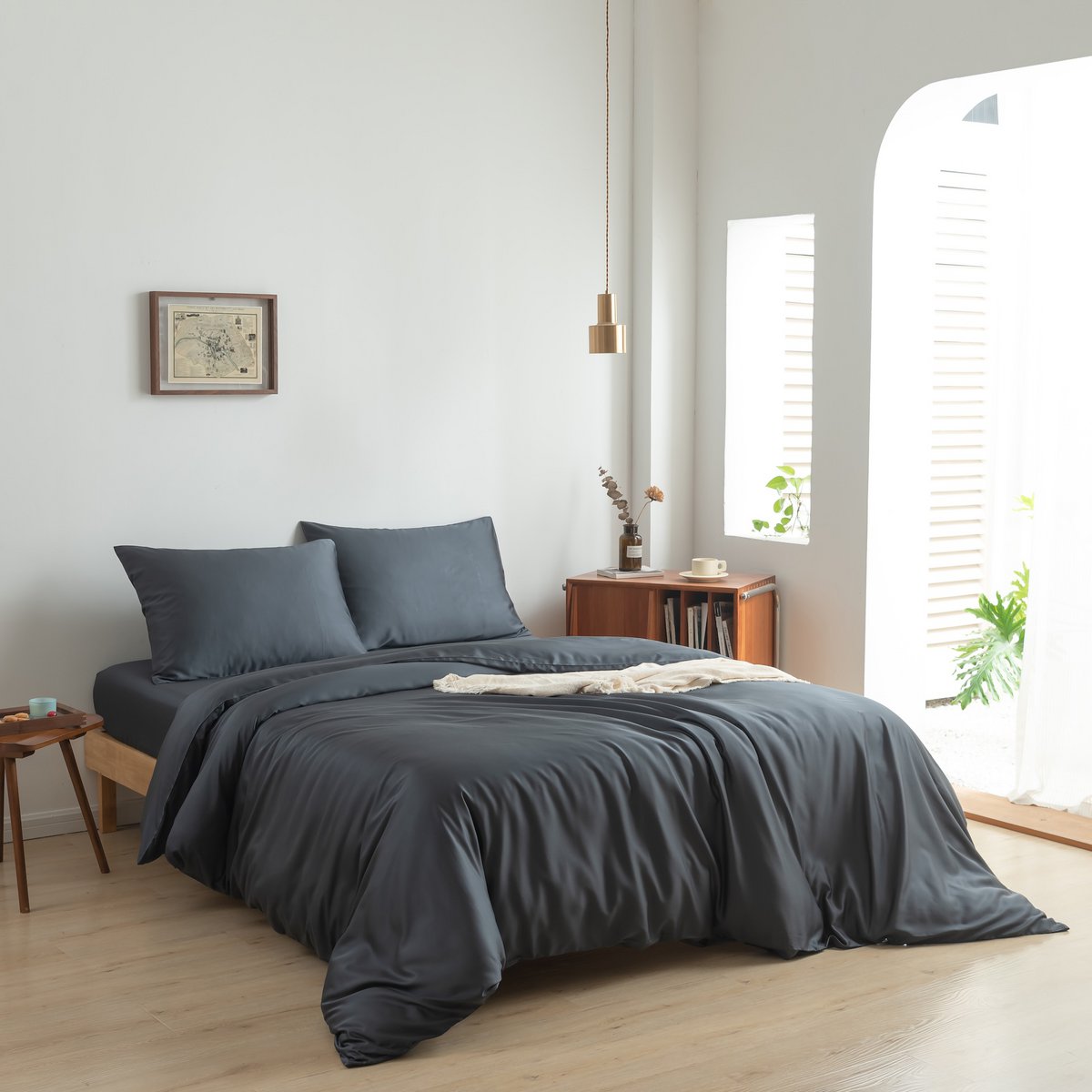 Space Blue bamboo bedding set on a fully made bed
