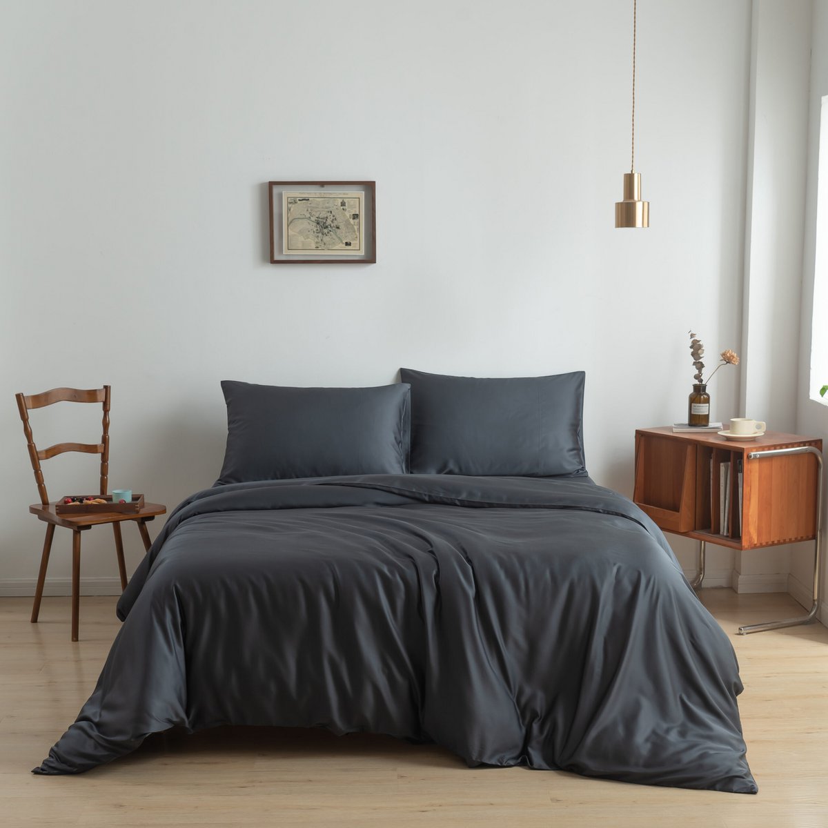 Space Blue bamboo bedding set styled on a bed by a window