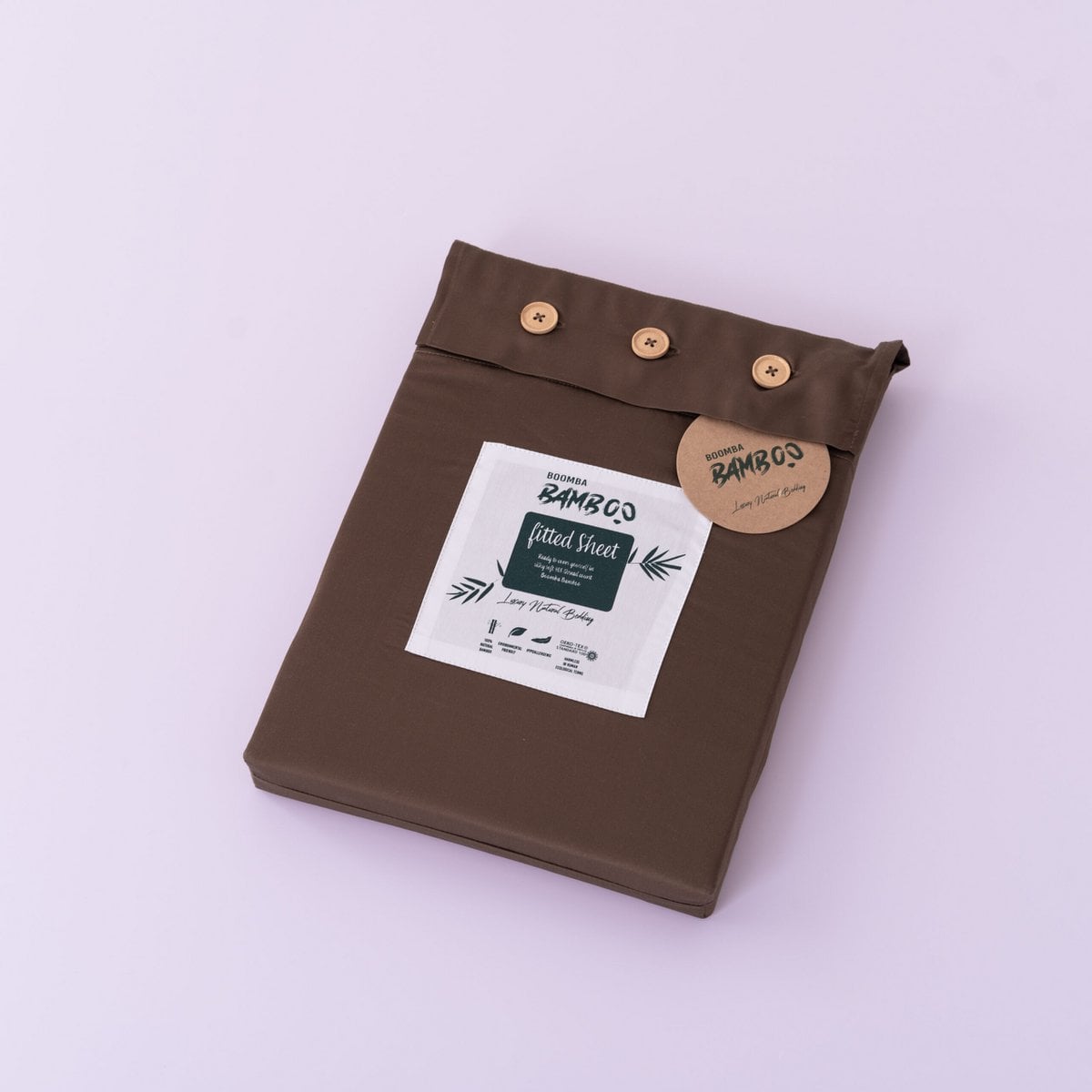 Coffee Brown bamboo fitted sheet folded and packaged with the Boomba Bamboo product label.