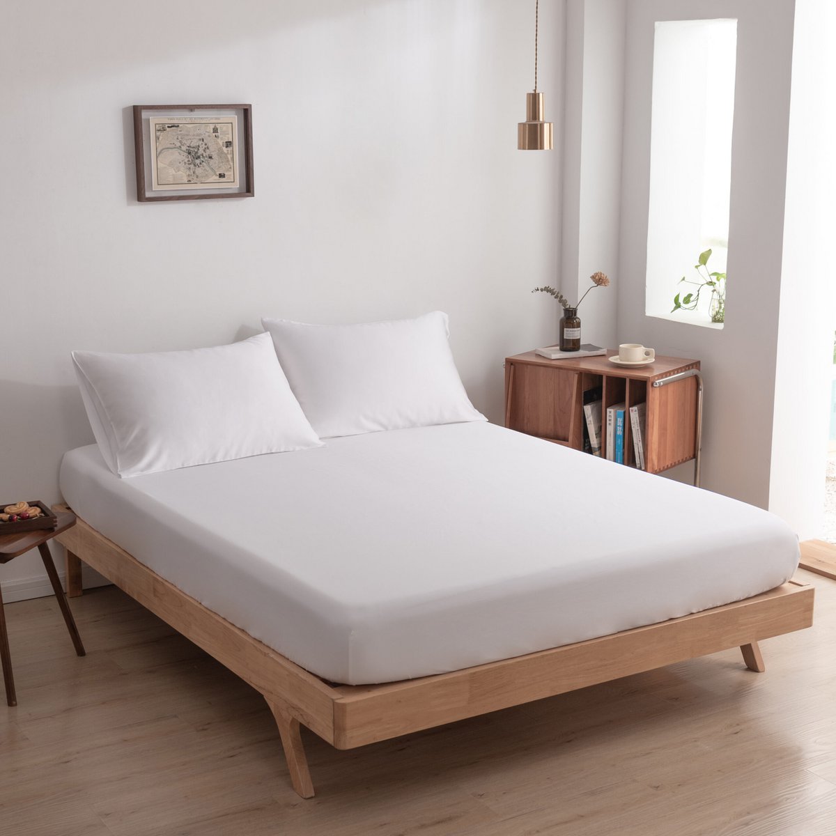 Coco White bamboo pillowcases on a wood-framed bed 02