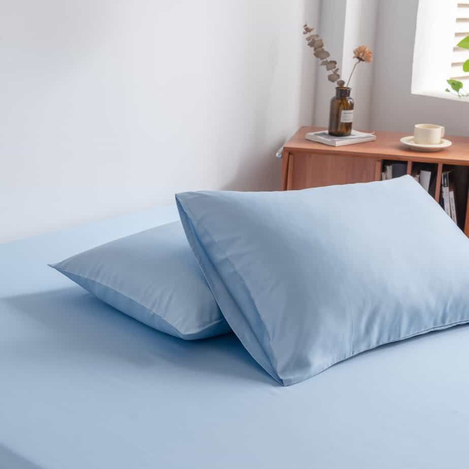Sky Blue bamboo pillowcases styled on a chair