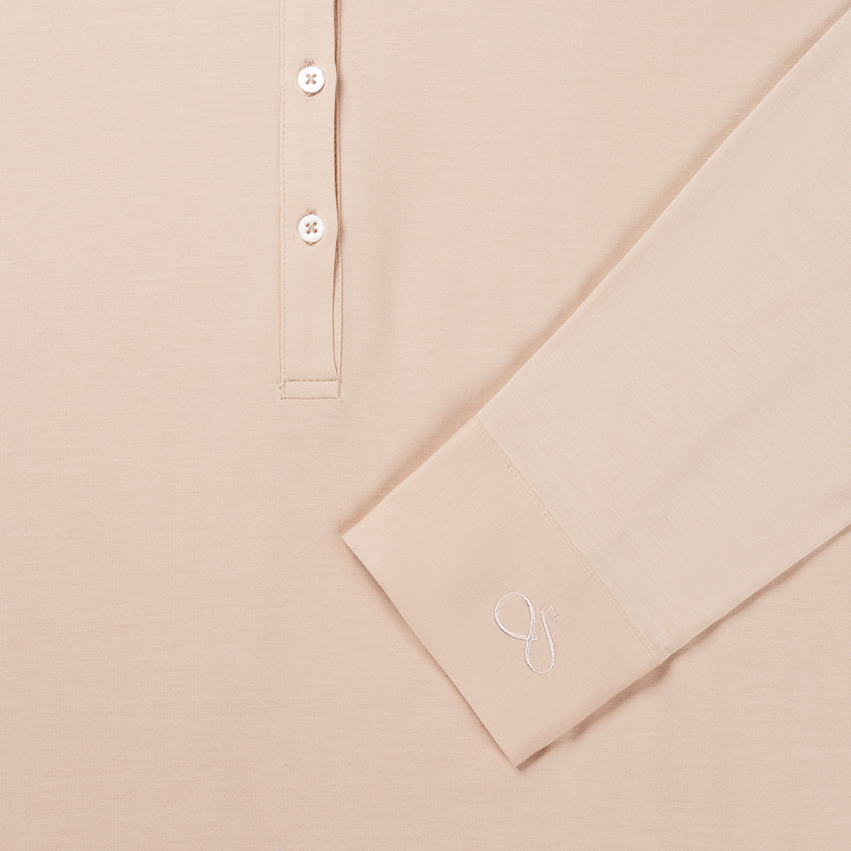 Close-up of the buttons and the embroidered cuff of the Powder Peach nightgown
