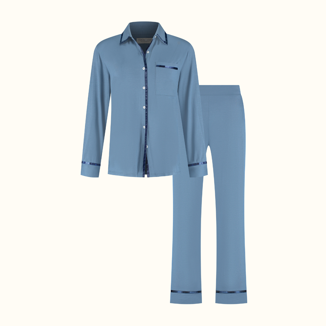 Dark Blue pyjama shirt and trousers on a plain background