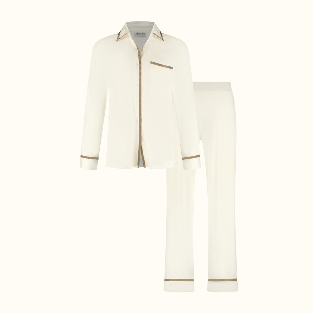Off White pyjama shirt and trousers on a plain background