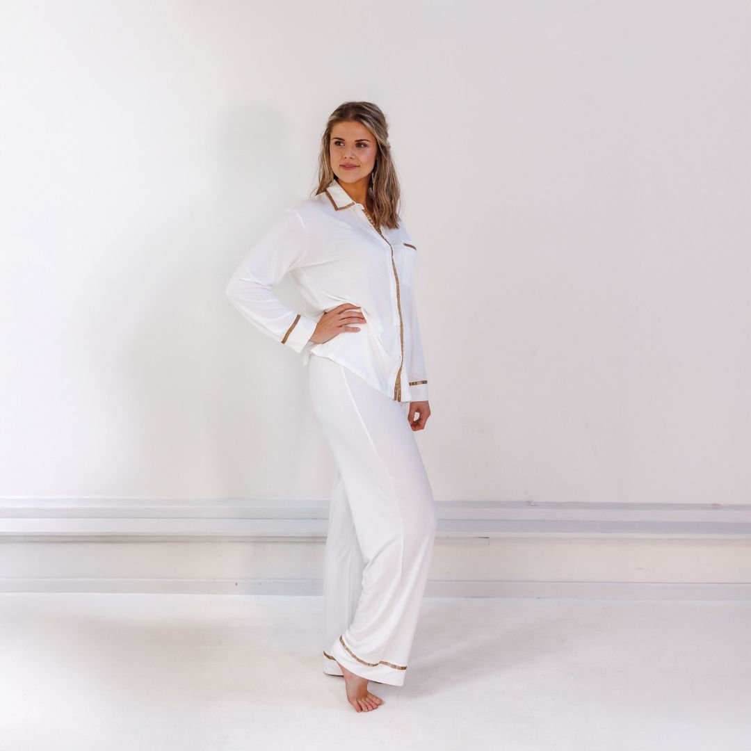 Woman in the Off White pyjama set with one hand on her hip