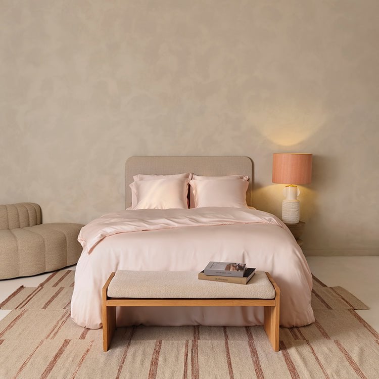 Tencel™ Sateen Duvet Cover in Peach White styled on a bed, wide view
