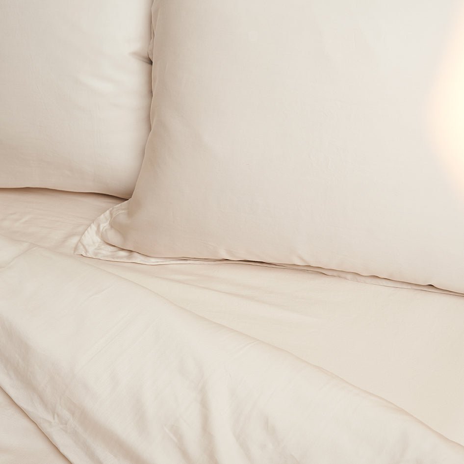 Tencel™ Twill Pillowcase in Beige on a made bed, flat view