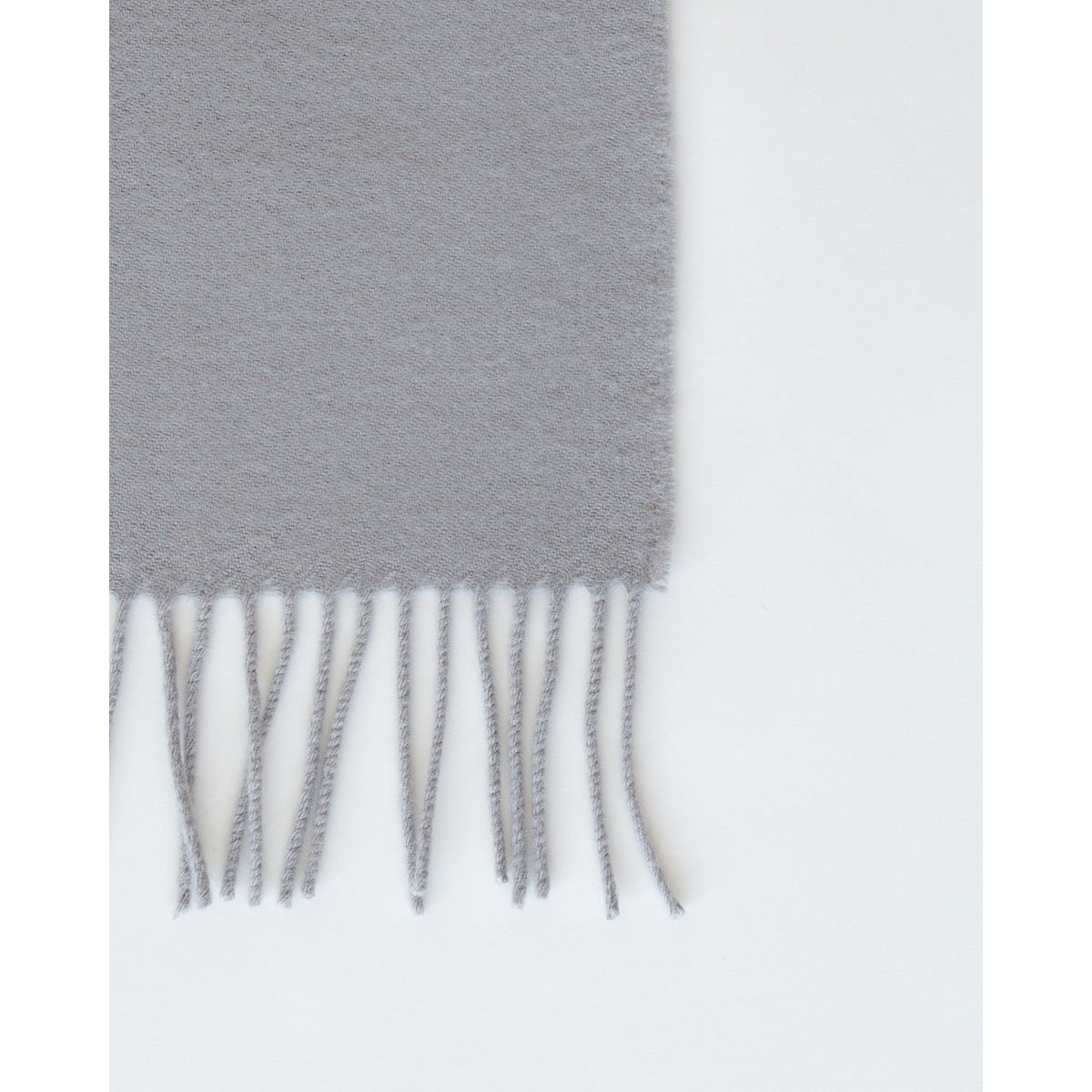 Fringed end of the Rio throw in grey