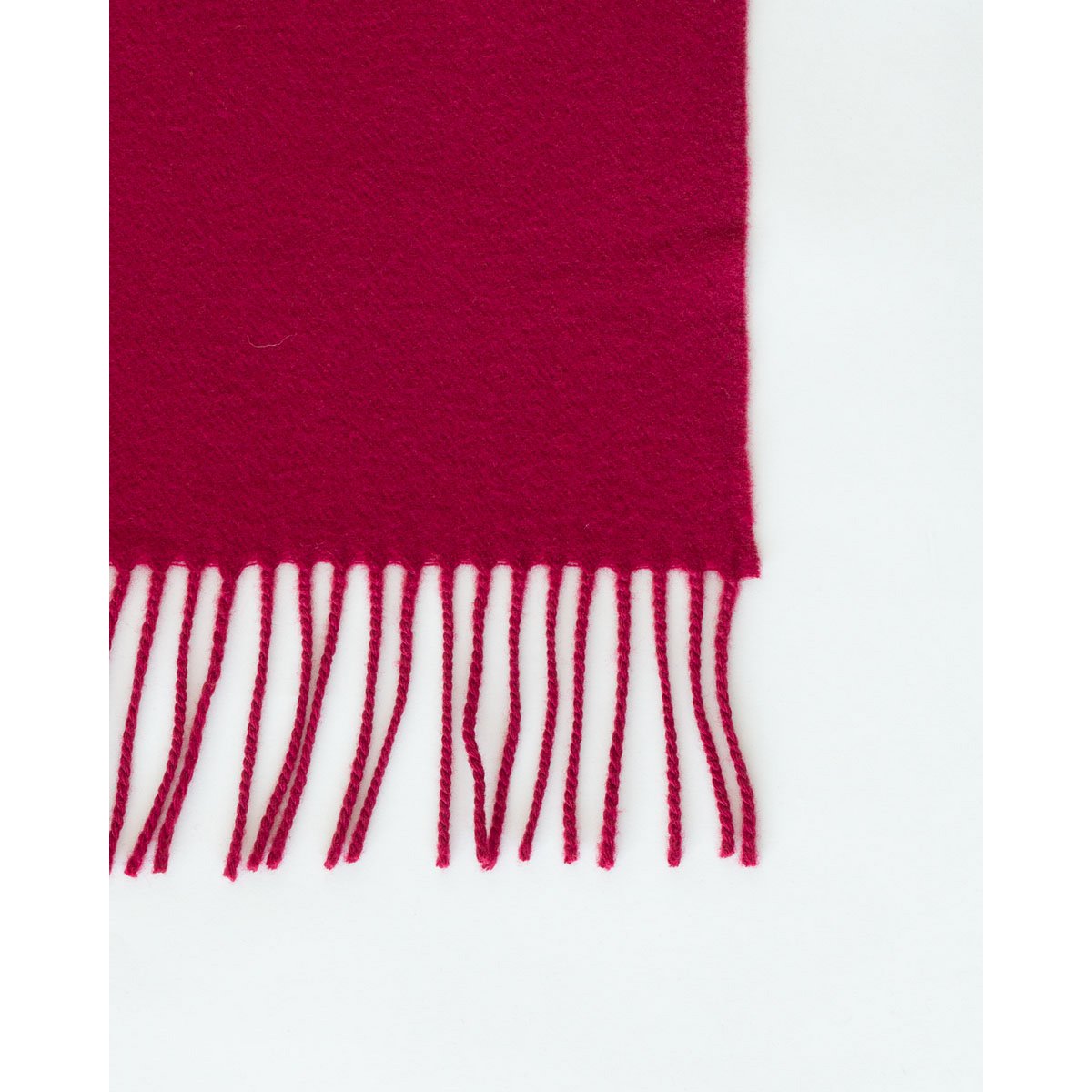 Fringed end of the Rio throw in red