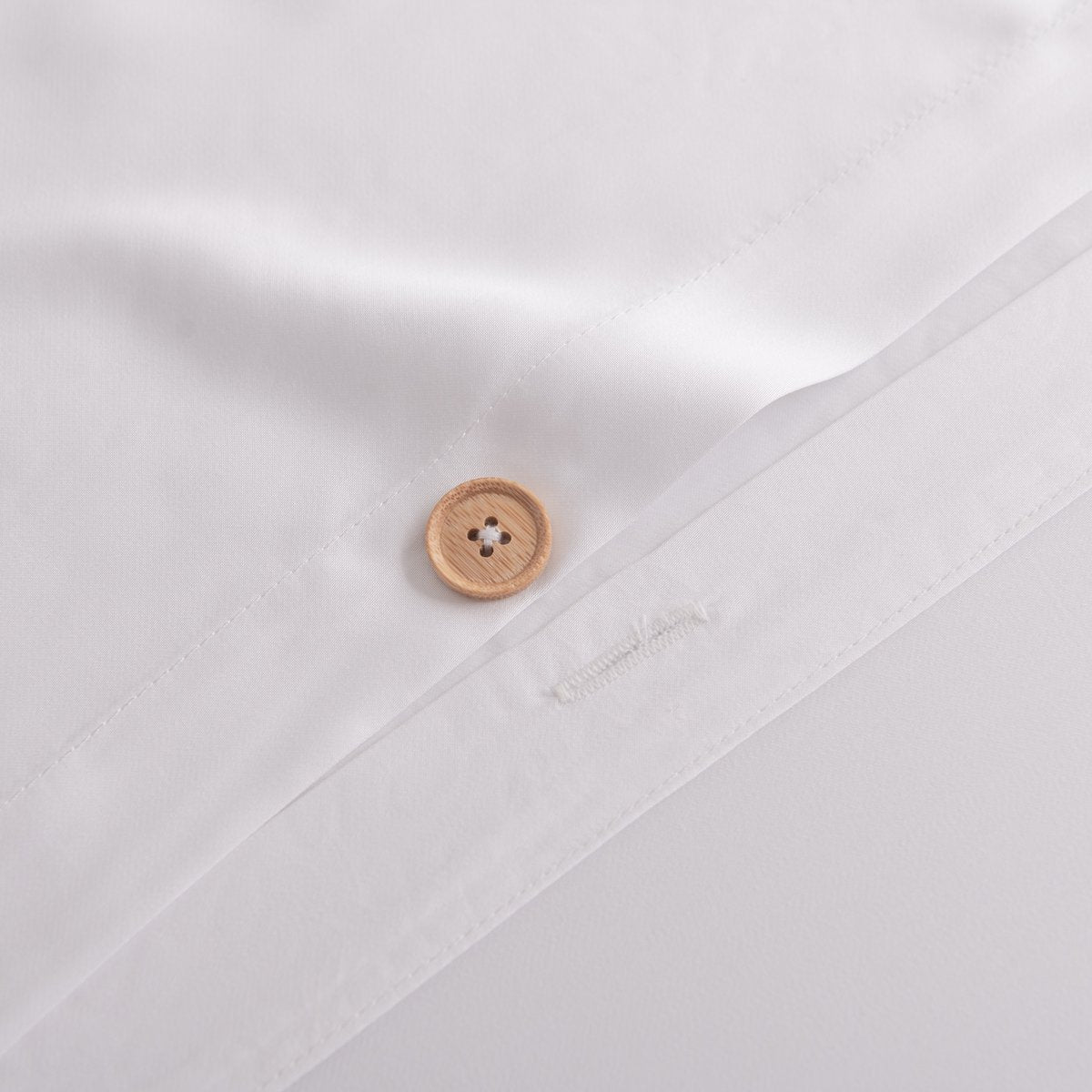 Close-up of the button/tag detail on the Coco White bamboo bedding