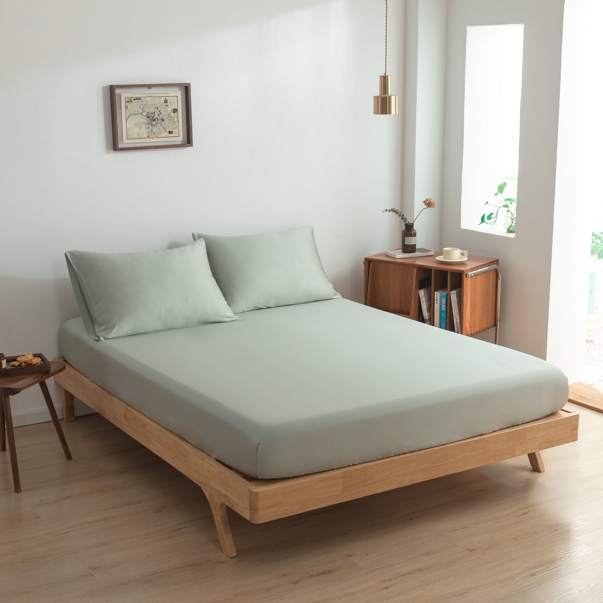 Sage Green bamboo bedding set on a bed by a window 02