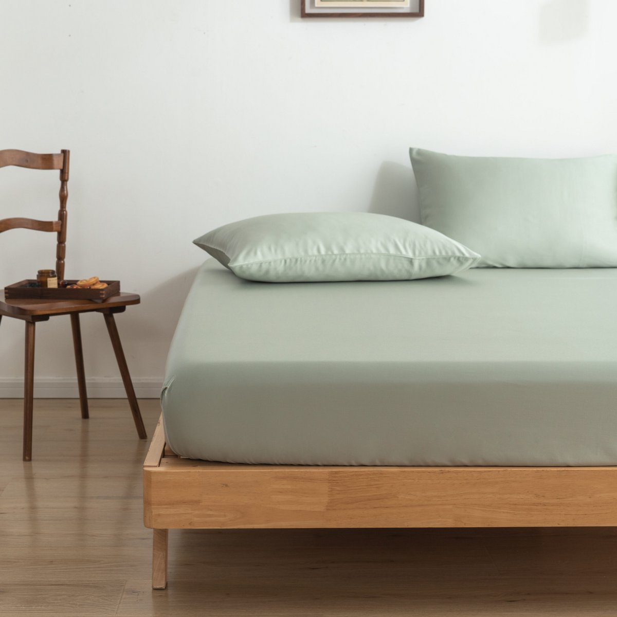 Sage Green bamboo bedding set on a bed by a window