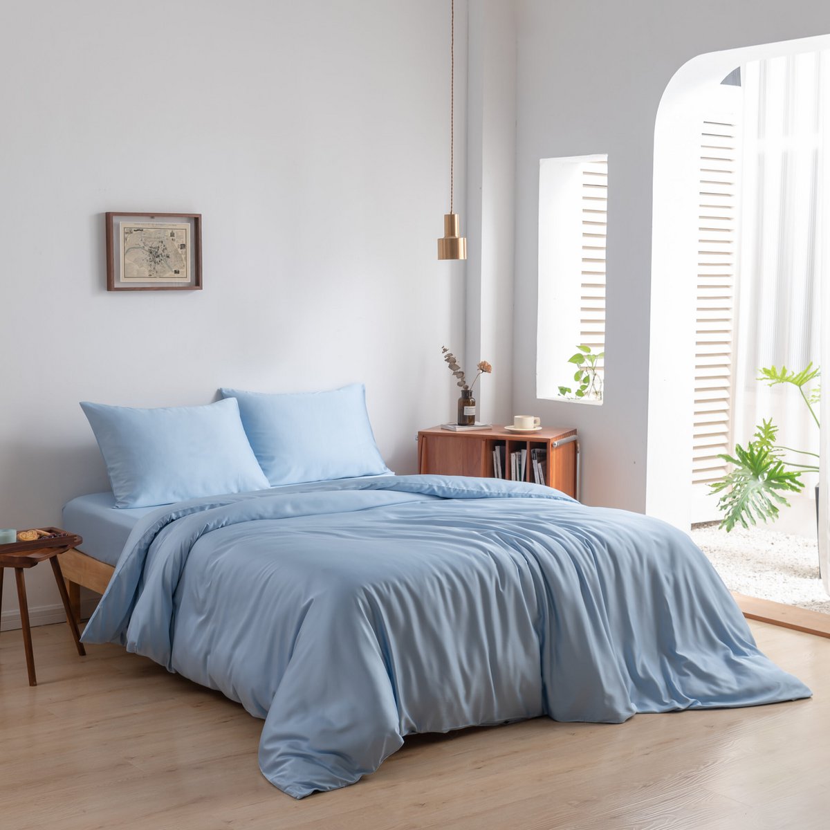 bedroom-lifestyle	Sky Blue bamboo bedding set styled on a bed by a window