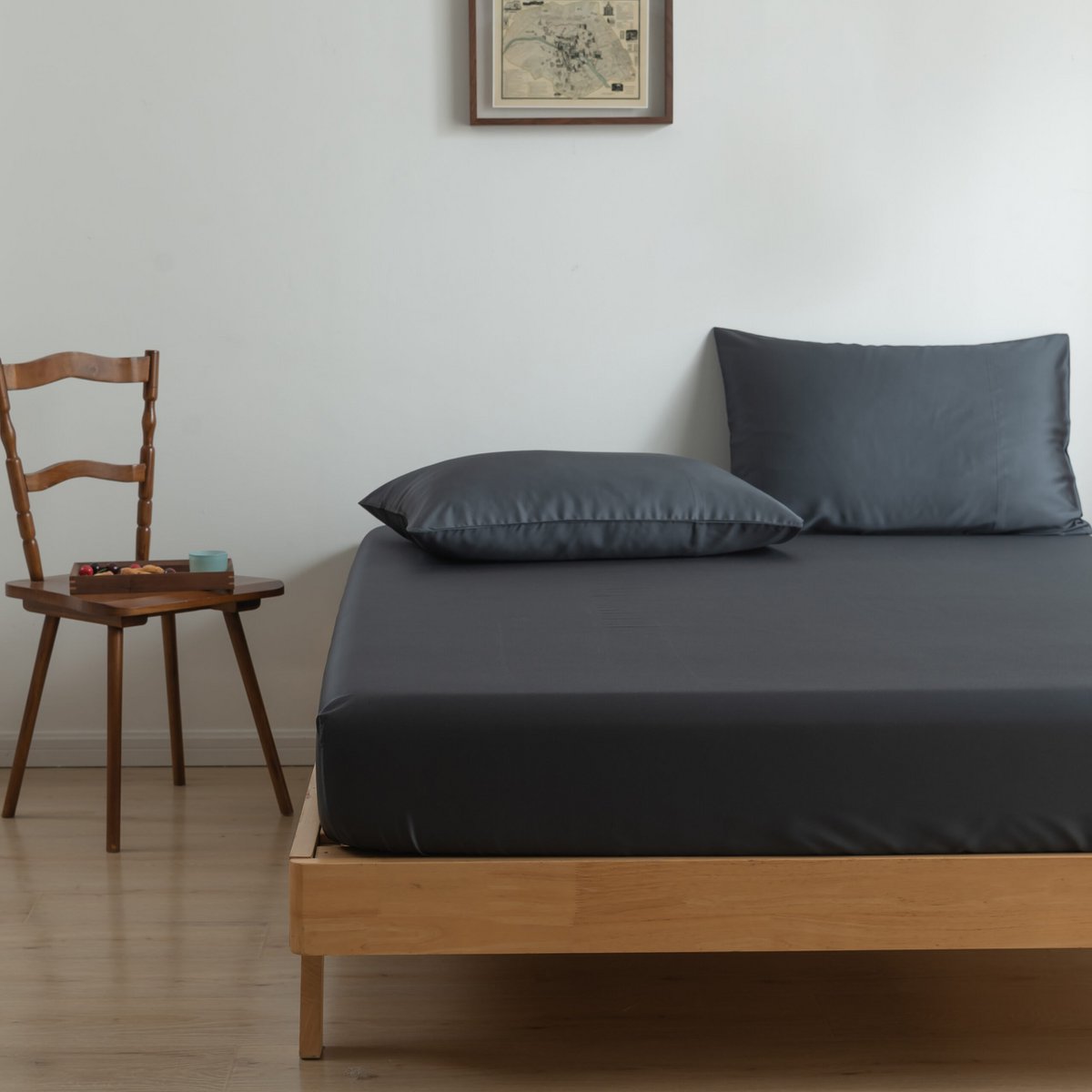 Space Blue bamboo bedding set on a wood-framed bed