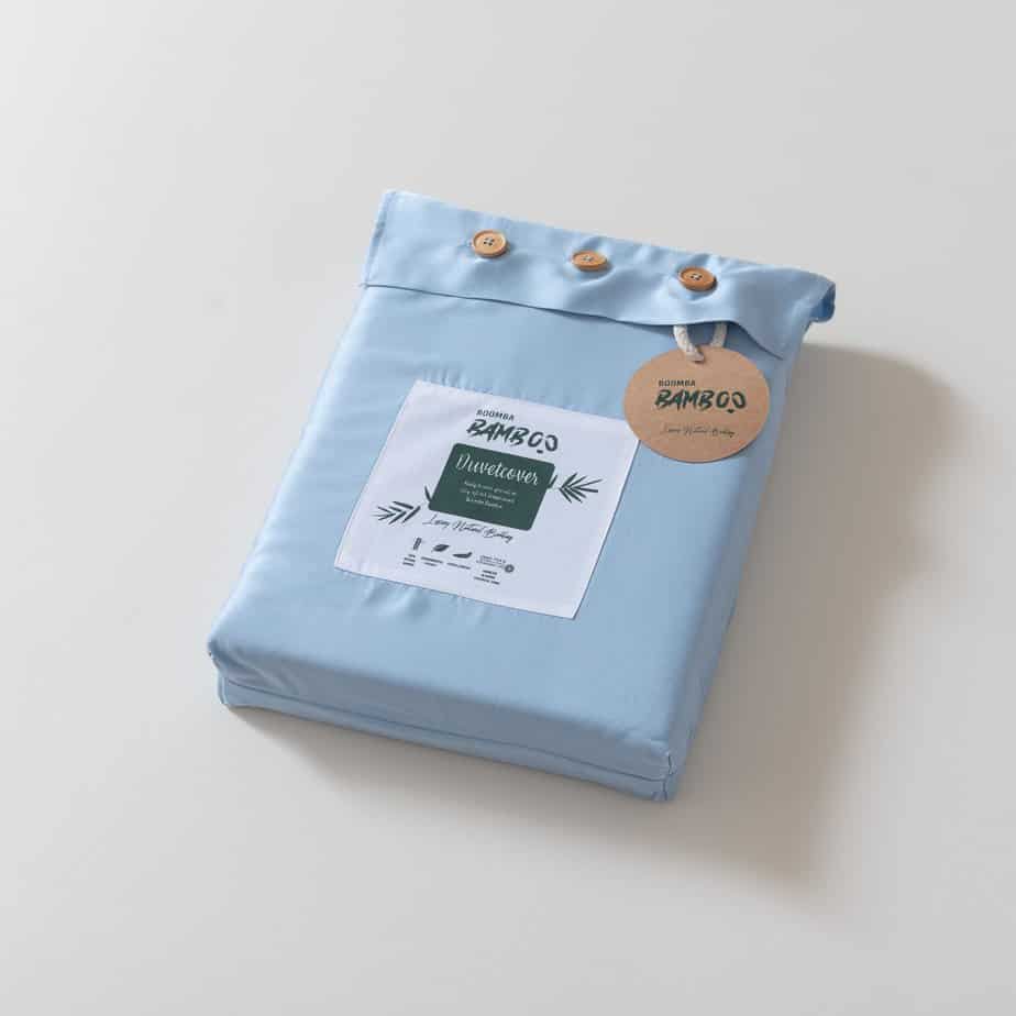 Folded Sky Blue bamboo duvet cover with bamboo buttons fastened and the Boomba Bamboo branded label and hang tag attached
