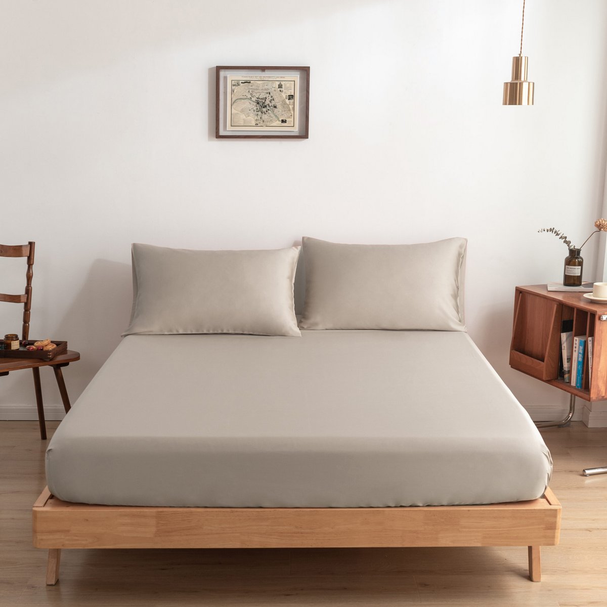 Soft Taupe bamboo fitted sheet on a made bed, shown straight-on with two matching pillows.