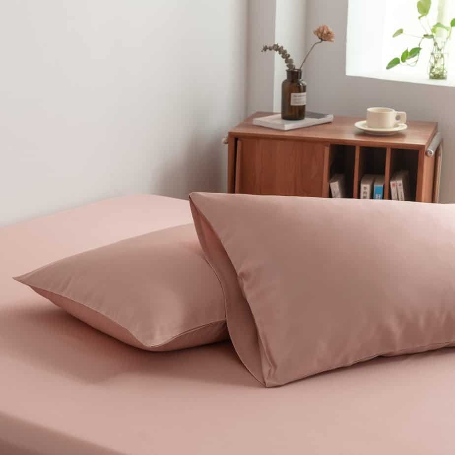 Cuddle Pink bamboo pillowcases styled on a chair