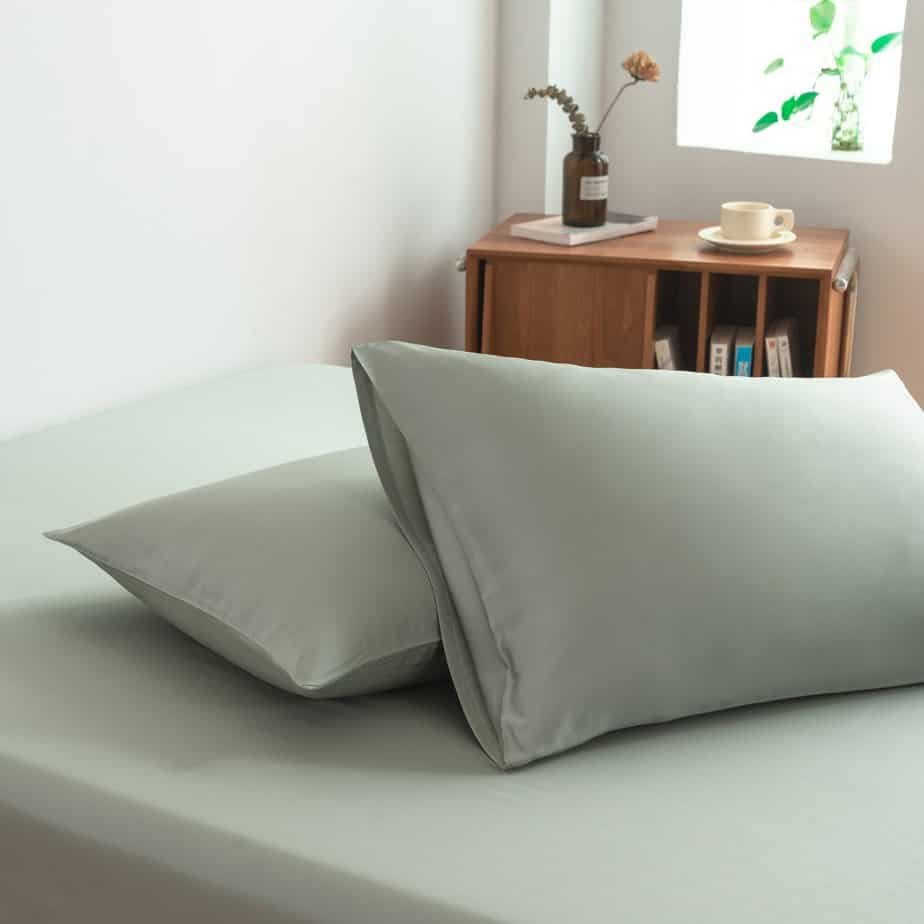 Sage Green bamboo pillowcases styled on a chair