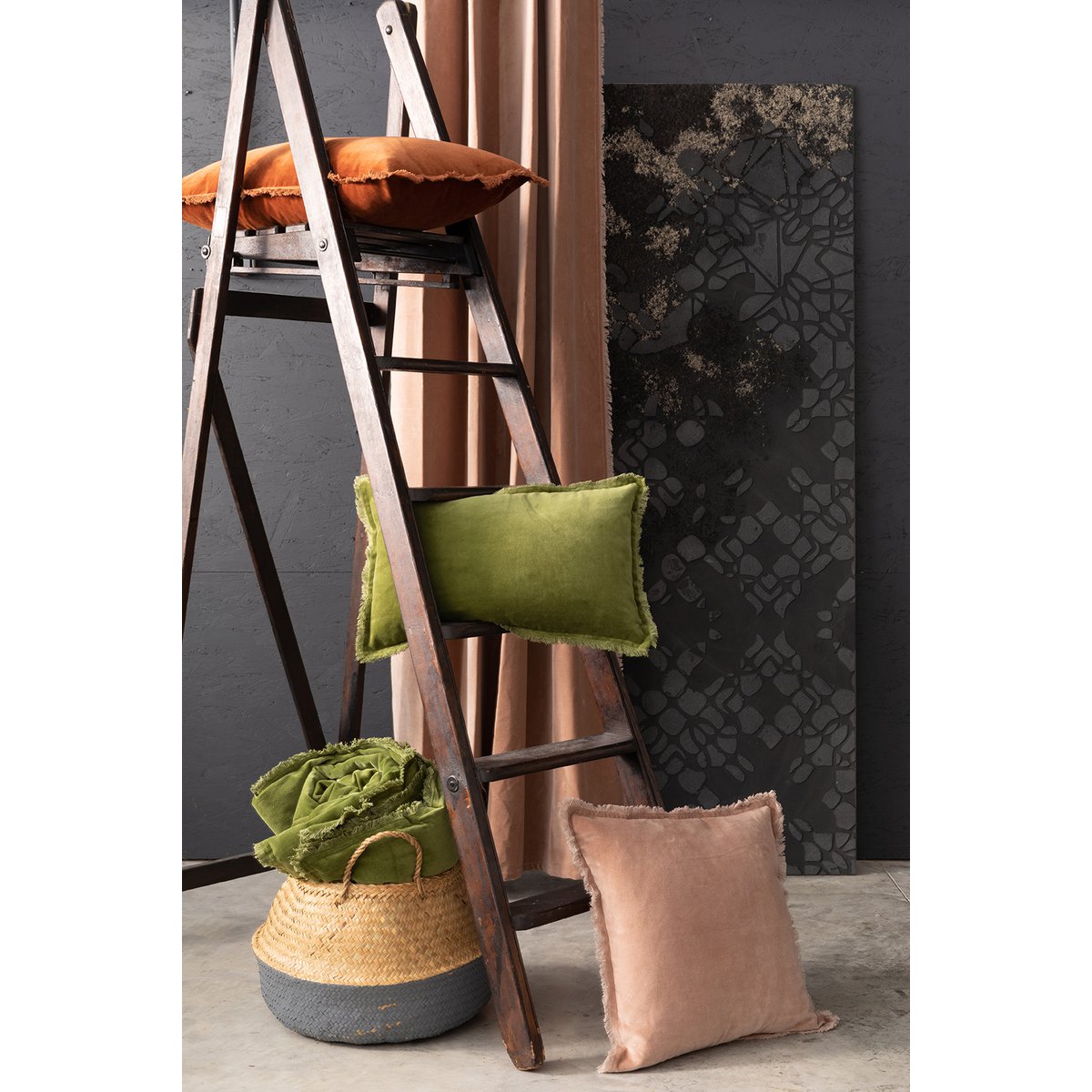 Fara velvet cushions and throw, styled with a wooden ladder