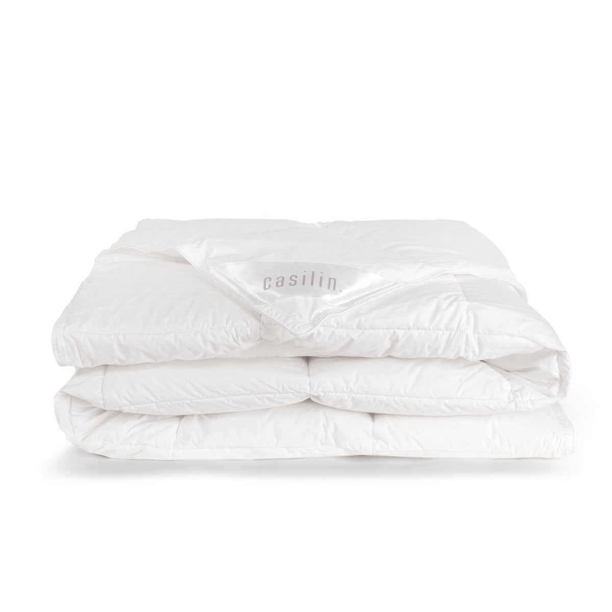 Folded white Casilin down duvet with the Casilin brand label visible on the corner
