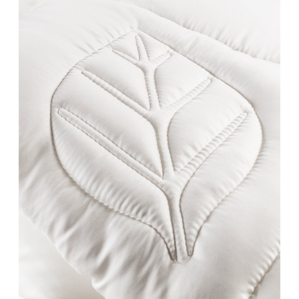 Close-up of the leaf-shaped quilting stitch pattern on the Tencel satin fabric of the Super Soft Light duvet