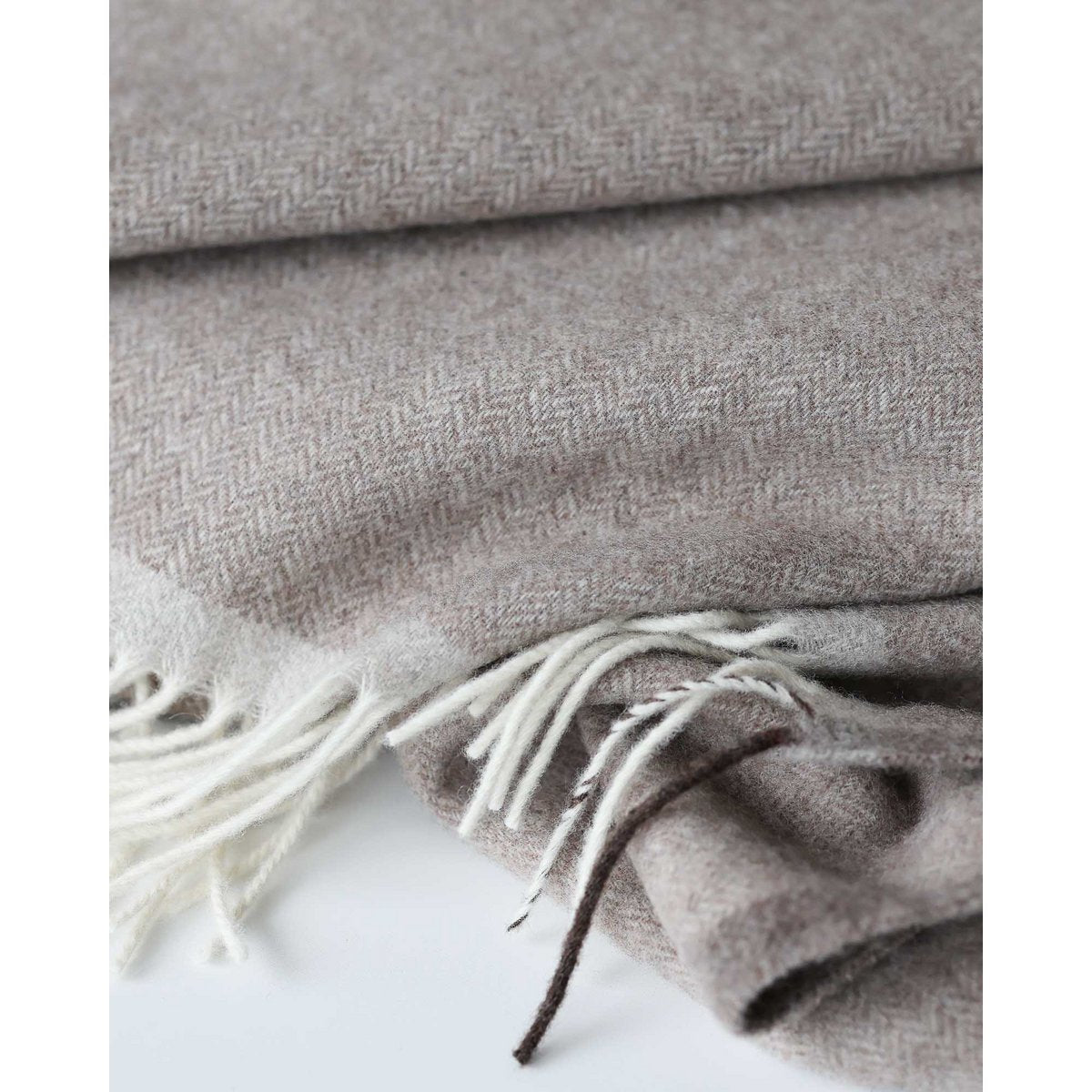 Close-up of Milano throw's soft cashmere-wool texture in brown
