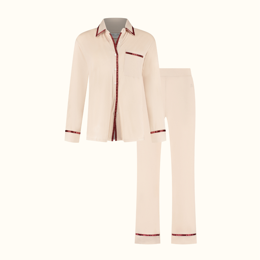 Powder Peach pyjama shirt and trousers on a plain background