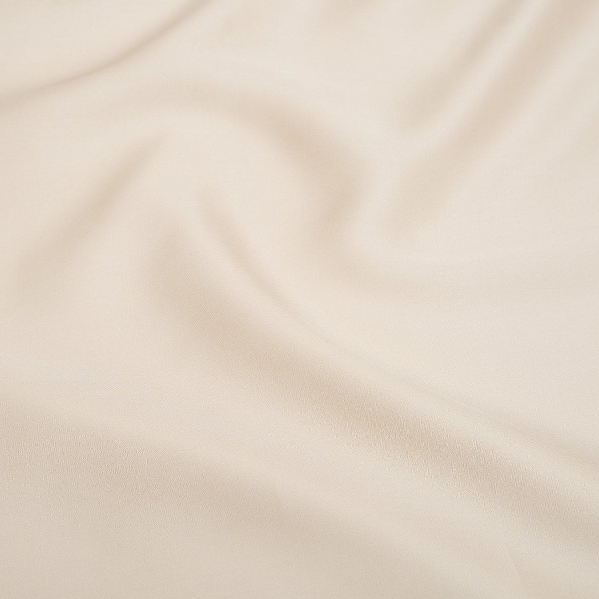 Close-up of the Tencel™ Sateen fabric draped, showing texture in White Sand