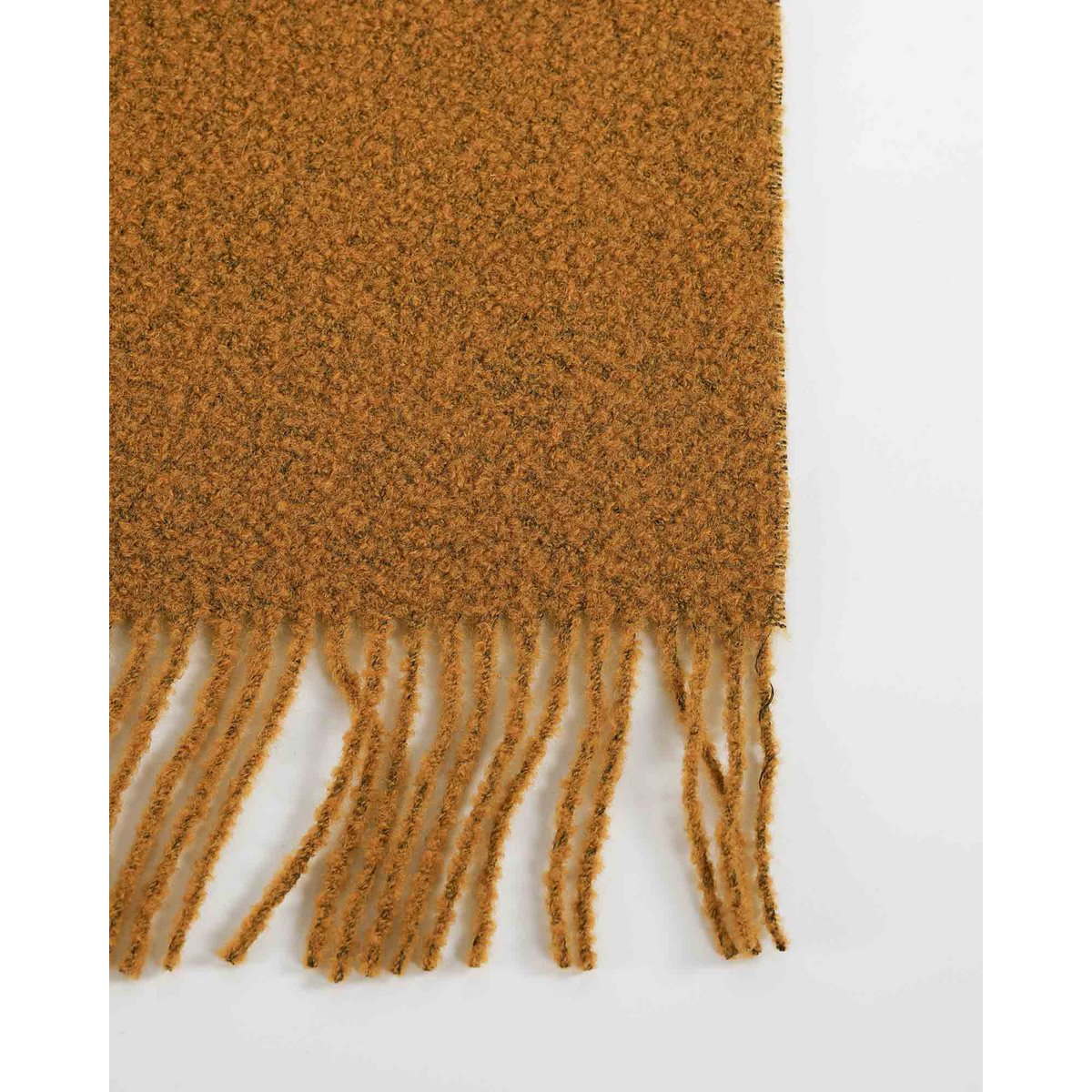 Close-up of Paris throw's bouclé texture in mustard yellow