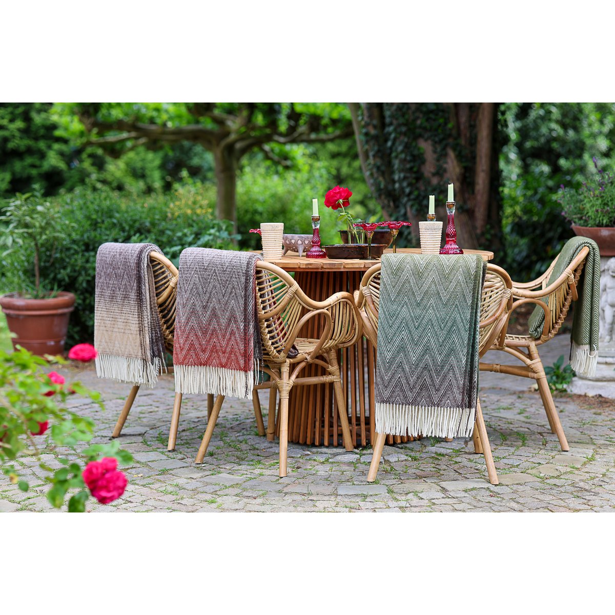 Manoria Savana throw styled near an outdoor table with floral setting